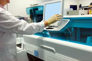 Scientist working with a computer screen in a lab